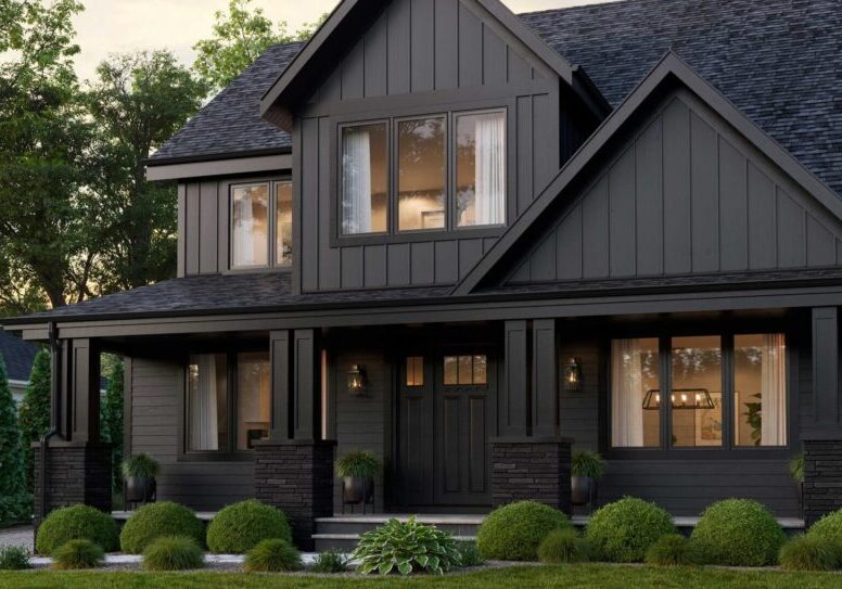 Dark-painted craftsman home with black-framed windows and a covered front porch
